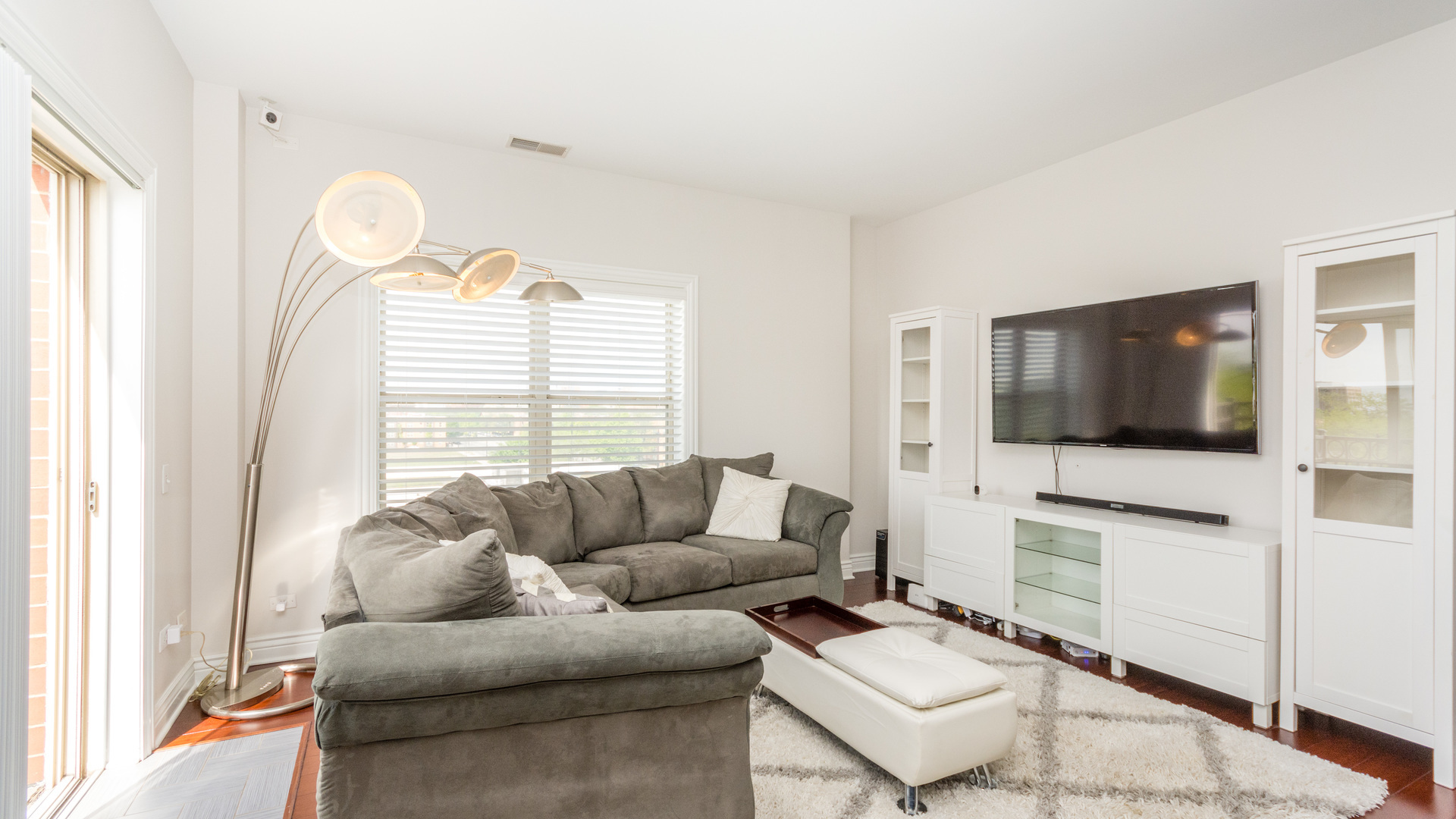 1155 West Roosevelt Road, Unit 401 Chicago, IL 60608 - Photo 8 of 35 a living room with furniture a flat screen tv and a window