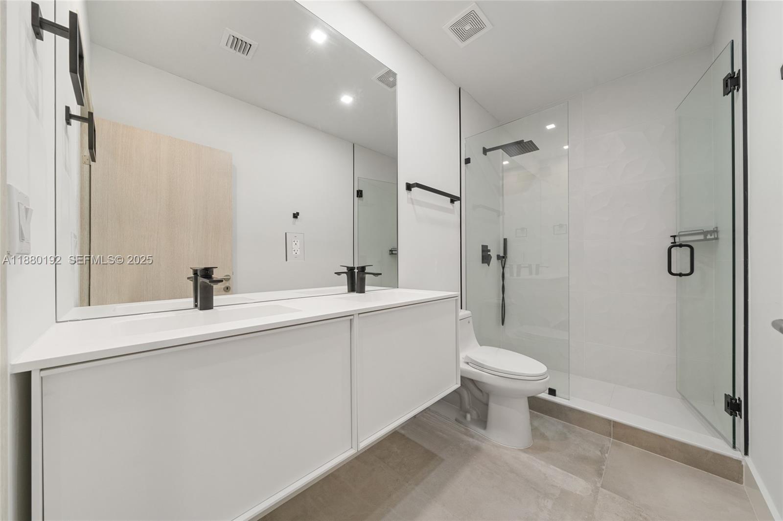 3431 Southwest 16th Terrace Miami, FL 33145 - Photo 20 of 33 a bathroom with a sink a toilet and shower