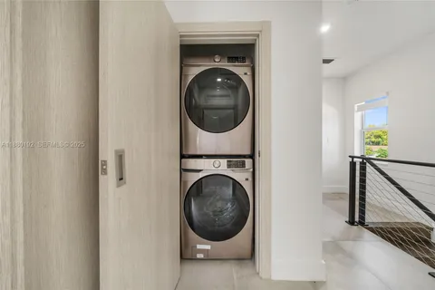 a view of a hallway with washer and dryer