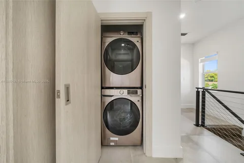 a view of a hallway with washer and dryer