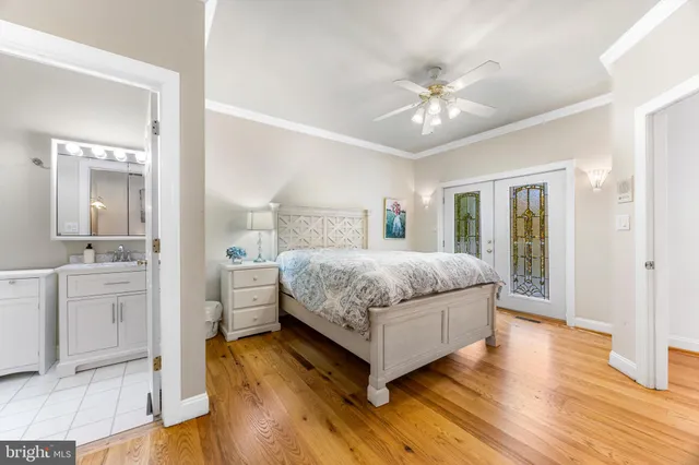 a bedroom with a large bed and a chandelier