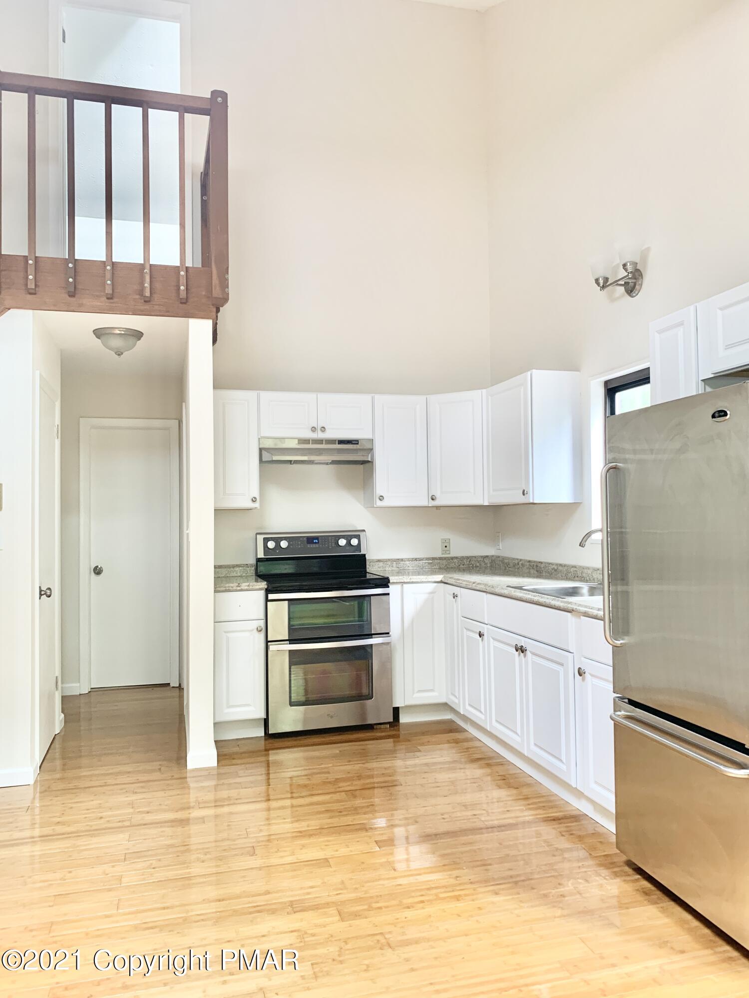185 Canterbury Road Bushkill, PA 18324 - Photo 4 of 27 a kitchen with stainless steel appliances granite countertop a refrigerator sink and stove