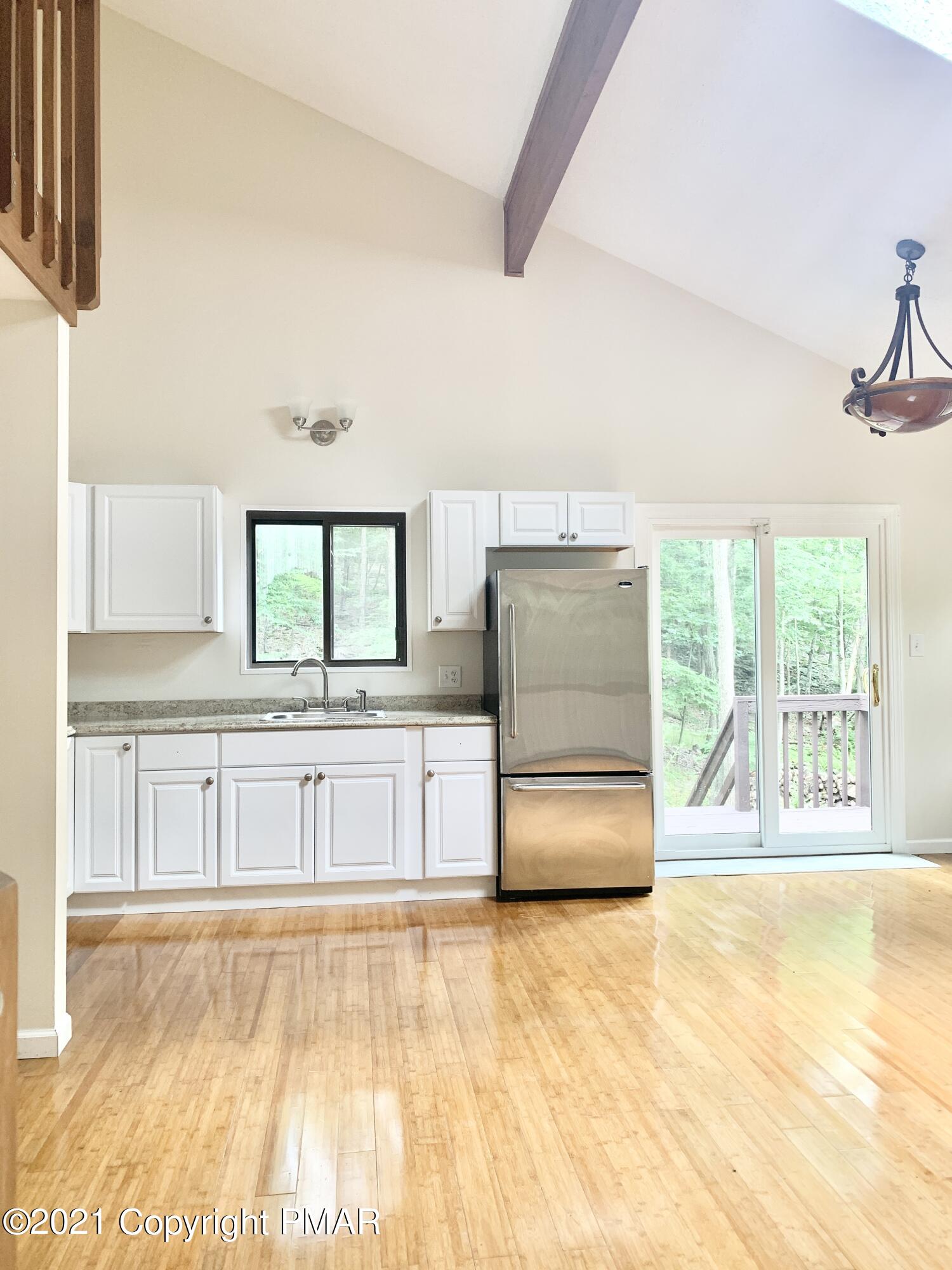 185 Canterbury Road Bushkill, PA 18324 - Photo 5 of 27 a kitchen with stainless steel appliances granite countertop a stove a sink and a white cabinets with wooden floor