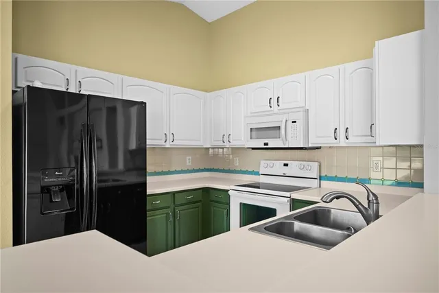 a kitchen with kitchen island a sink a stove and refrigerator