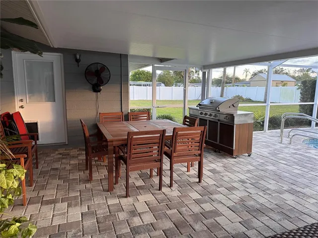 a view of a patio with a dining table and chairs