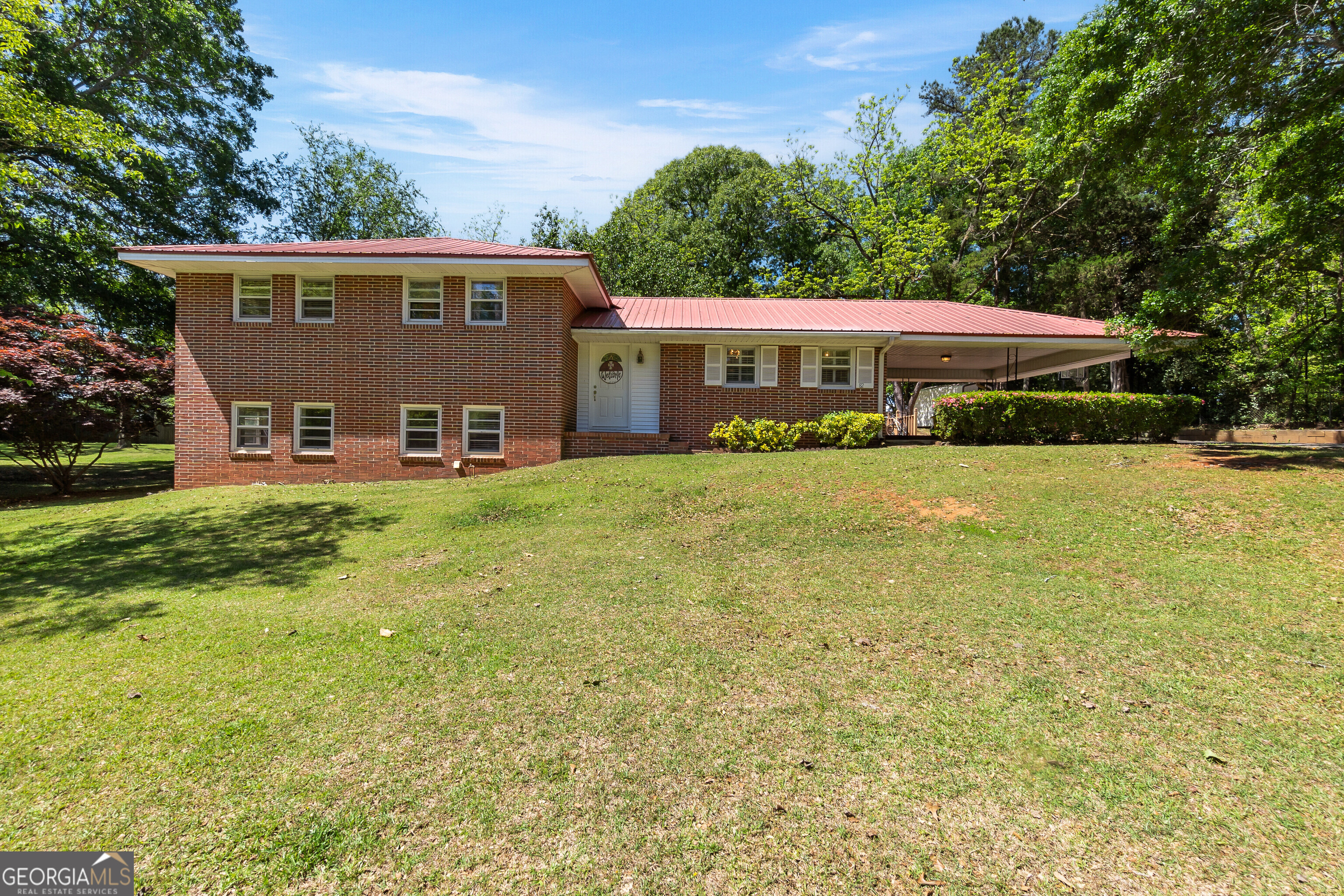 a view of a house with pool and yard