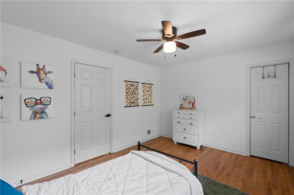 799 Pine Roc Drive Stone Mountain, GA 30083 - Photo 21 of 30 a bedroom with a bed and a chandelier