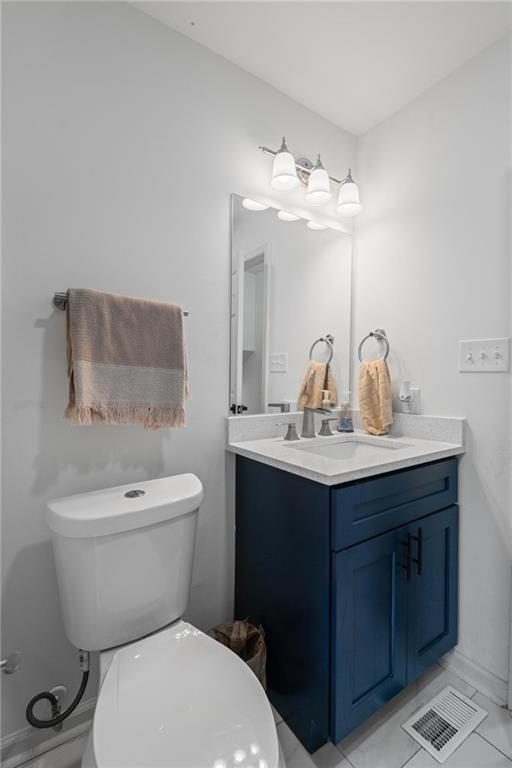 799 Pine Roc Drive Stone Mountain, GA 30083 - Photo 25 of 30 a bathroom with a toilet sink and mirror