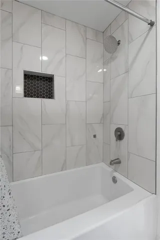 a bathroom with a shower and a bathtub