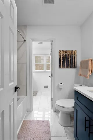 a bathroom with a toilet a sink and bathtub