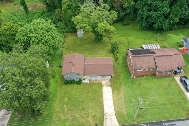 an aerial view of a house with a yard and lake view