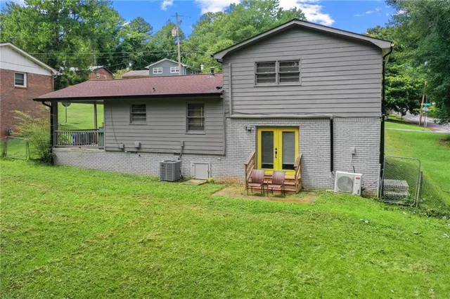 a view of a house with a yard and sitting area