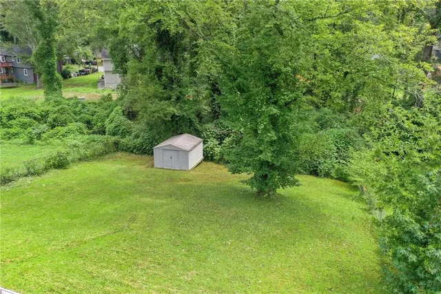 a backyard of a house with a yard and entertaining space