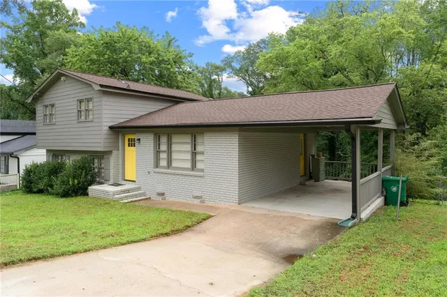 a front view of a house with a garden and yard