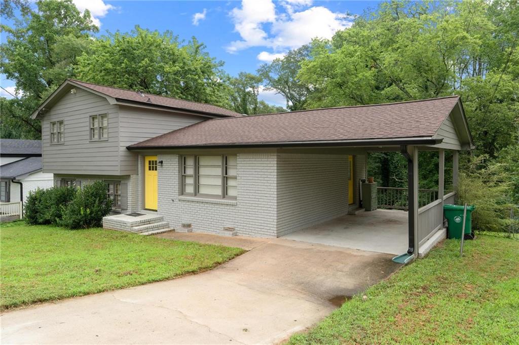 799 Pine Roc Drive Stone Mountain, GA 30083 - Photo 3 of 30 a front view of a house with a garden and yard