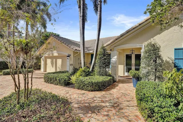 a front view of a house with a garden