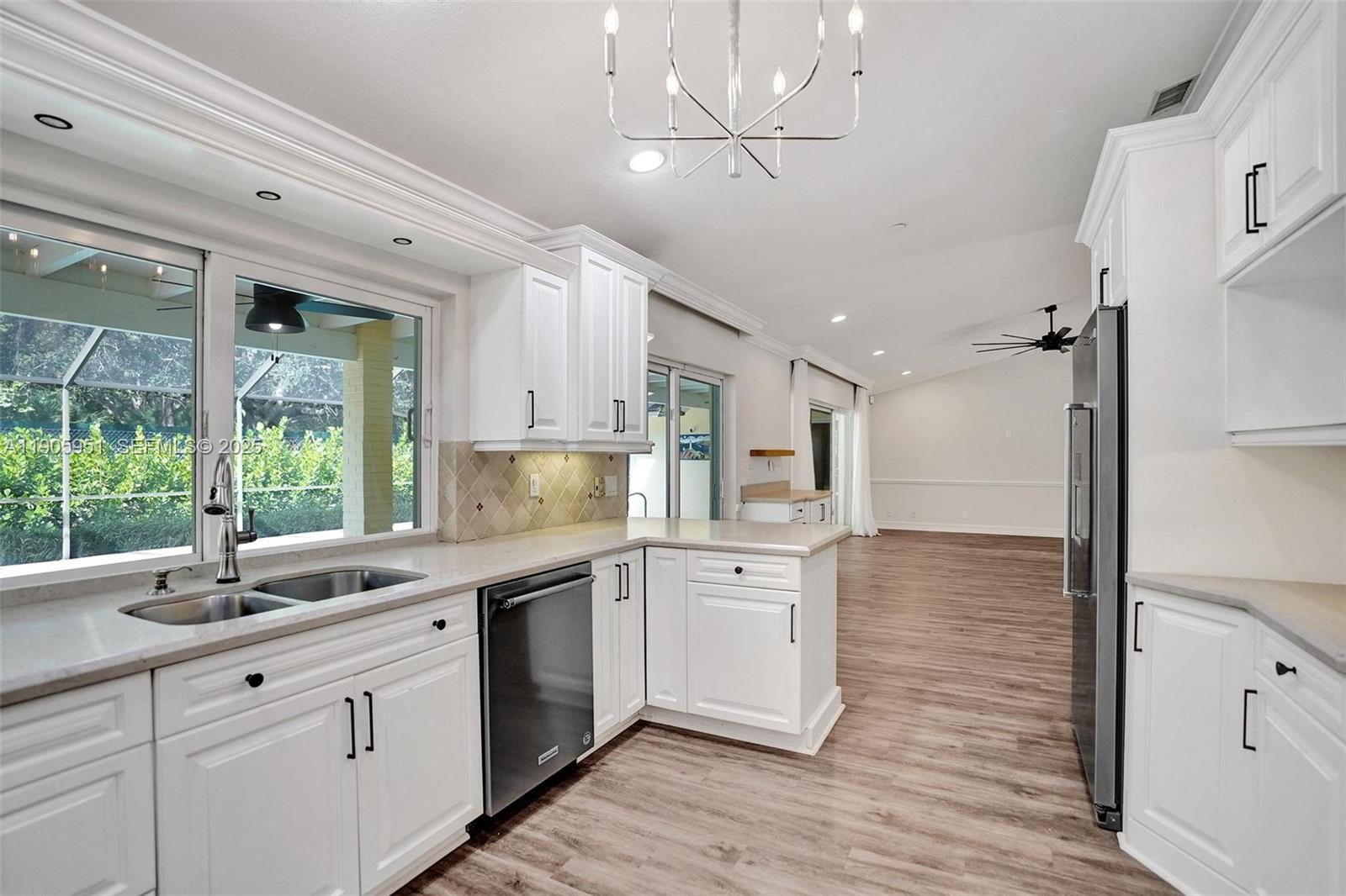 3801 Northwest 27th Avenue Boca Raton, FL 33434 - Photo 30 of 100 a kitchen with a sink appliances cabinets and a large window
