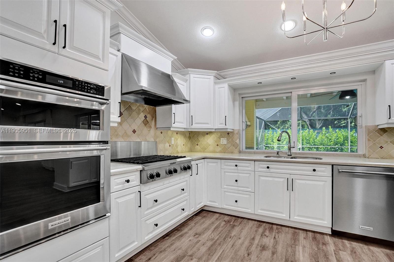 3801 Northwest 27th Avenue Boca Raton, FL 33434 - Photo 32 of 100 a kitchen with granite countertop white cabinets white stainless steel appliances and a sink