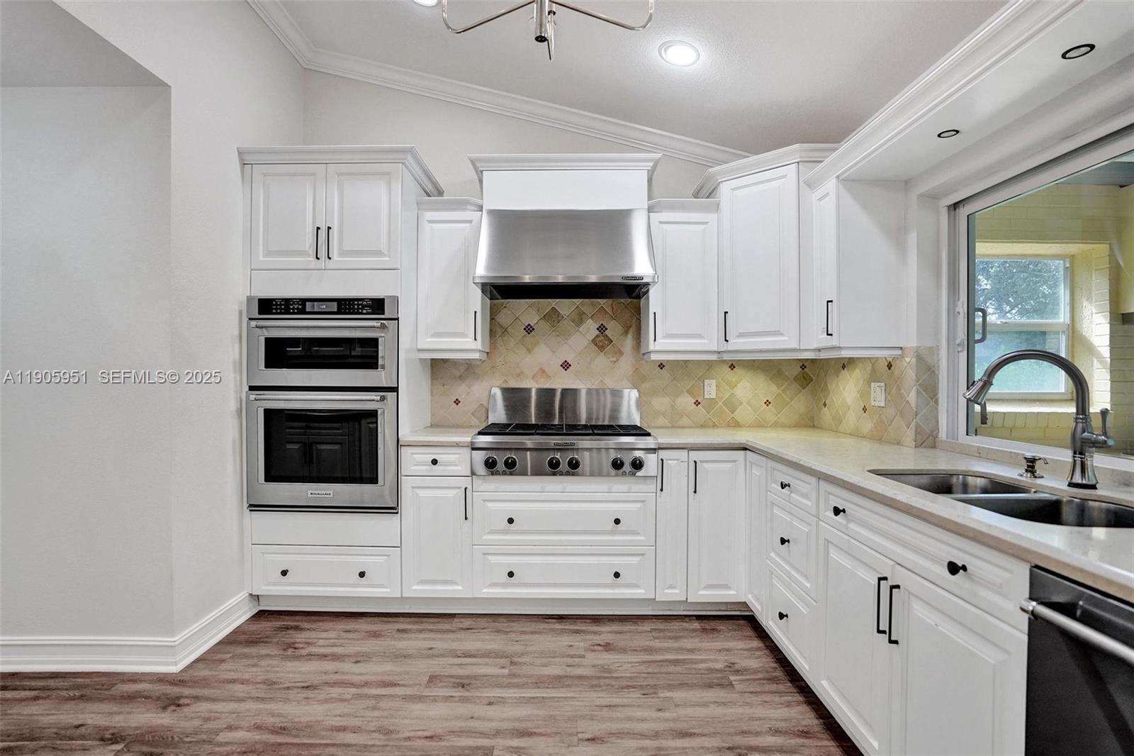 3801 Northwest 27th Avenue Boca Raton, FL 33434 - Photo 38 of 100 a kitchen with stainless steel appliances granite countertop a stove and white cabinets