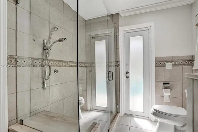 an aerial view of residential houses with outdoor space and trees