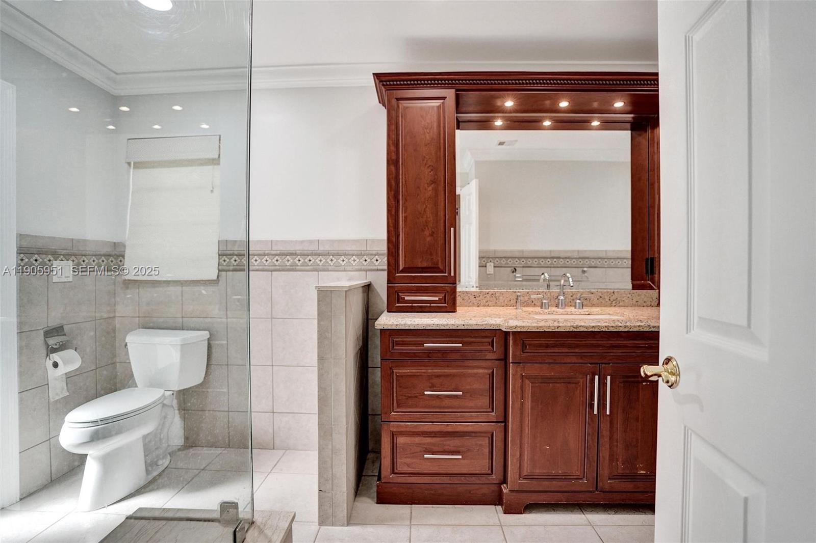 3801 Northwest 27th Avenue Boca Raton, FL 33434 - Photo 55 of 100 a bathroom with a toilet a sink and mirror