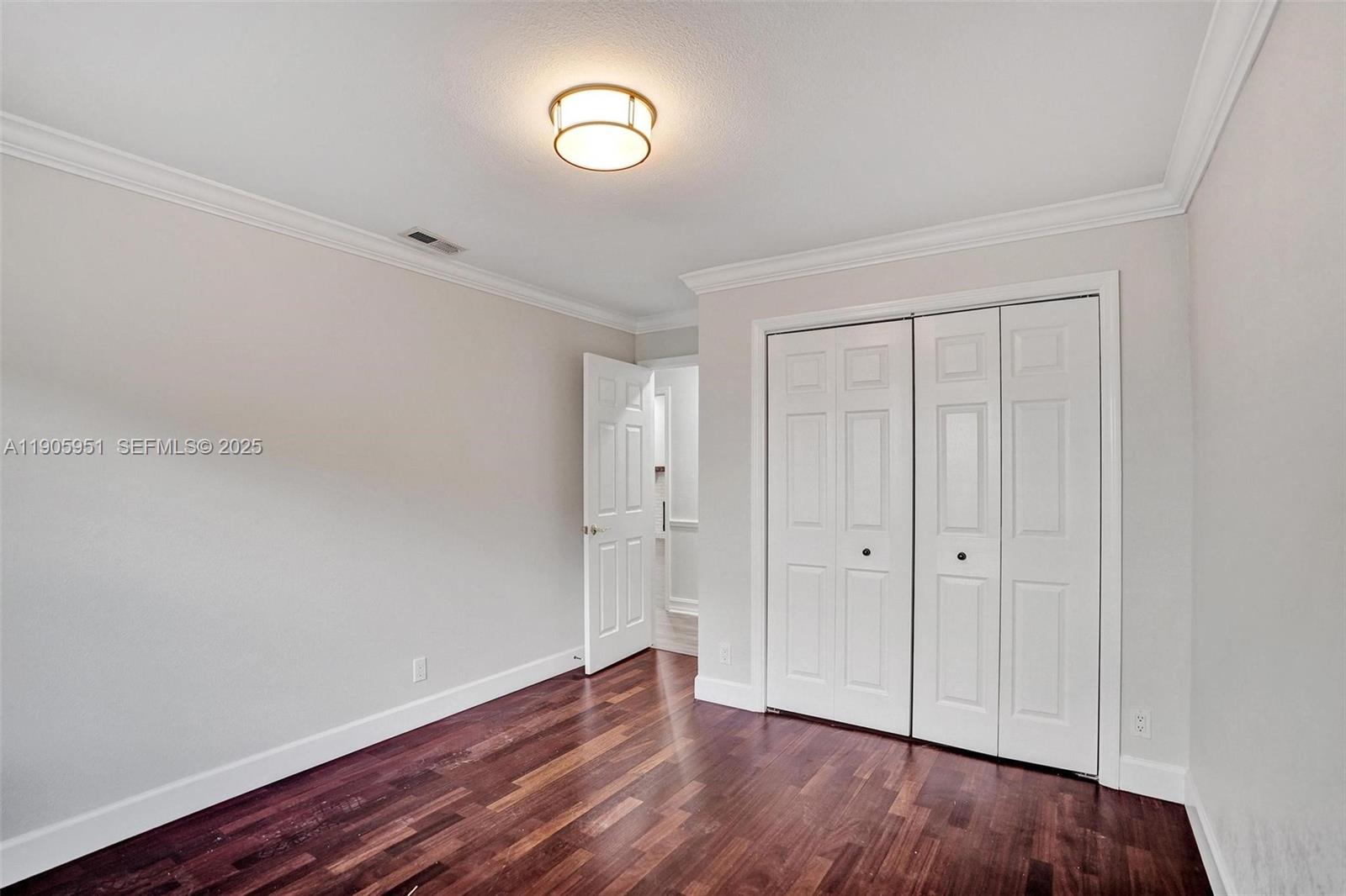 3801 Northwest 27th Avenue Boca Raton, FL 33434 - Photo 67 of 100 a view of an empty room with wooden floor