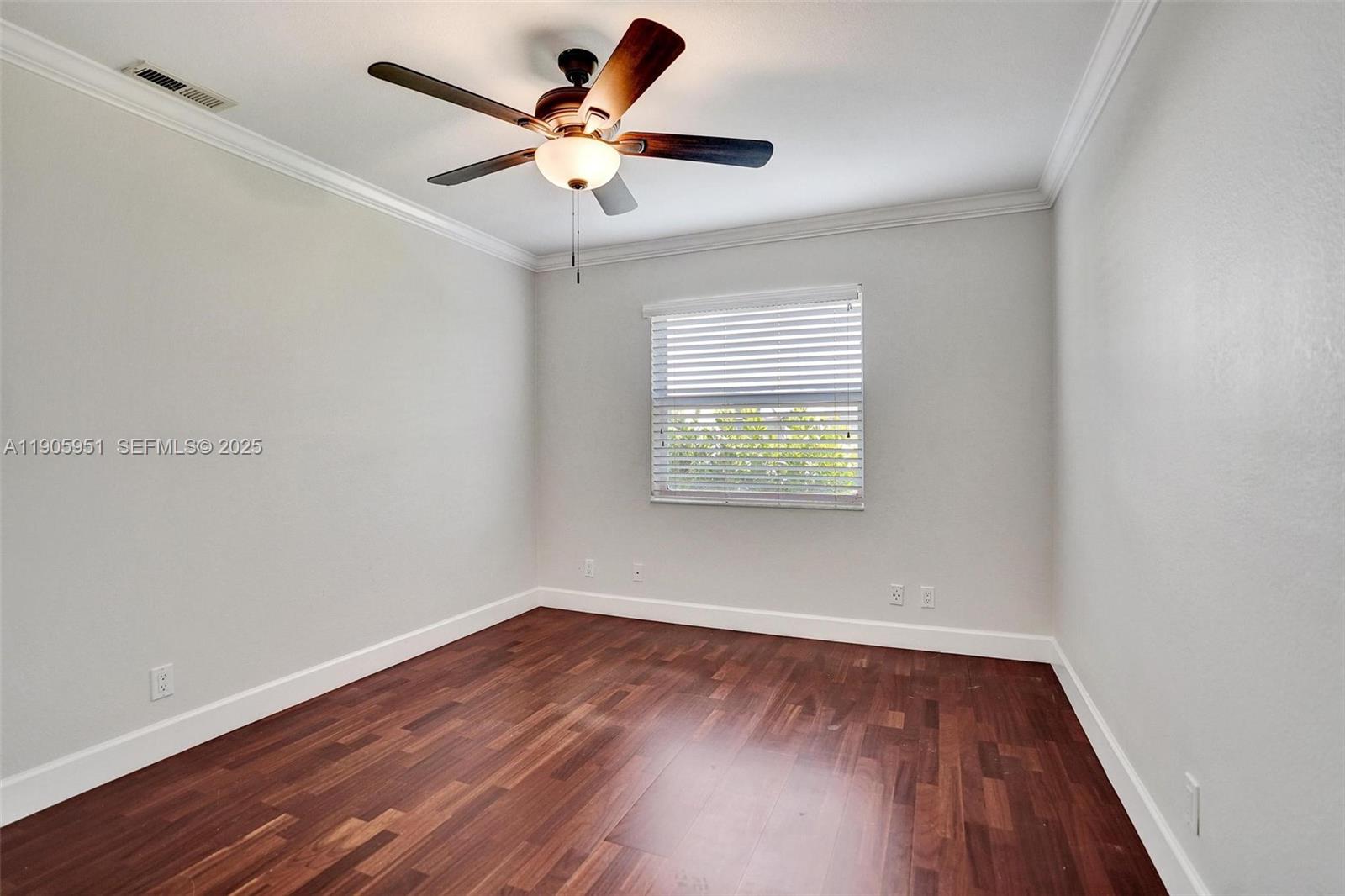 3801 Northwest 27th Avenue Boca Raton, FL 33434 - Photo 73 of 100 an empty room with wooden floor and windows