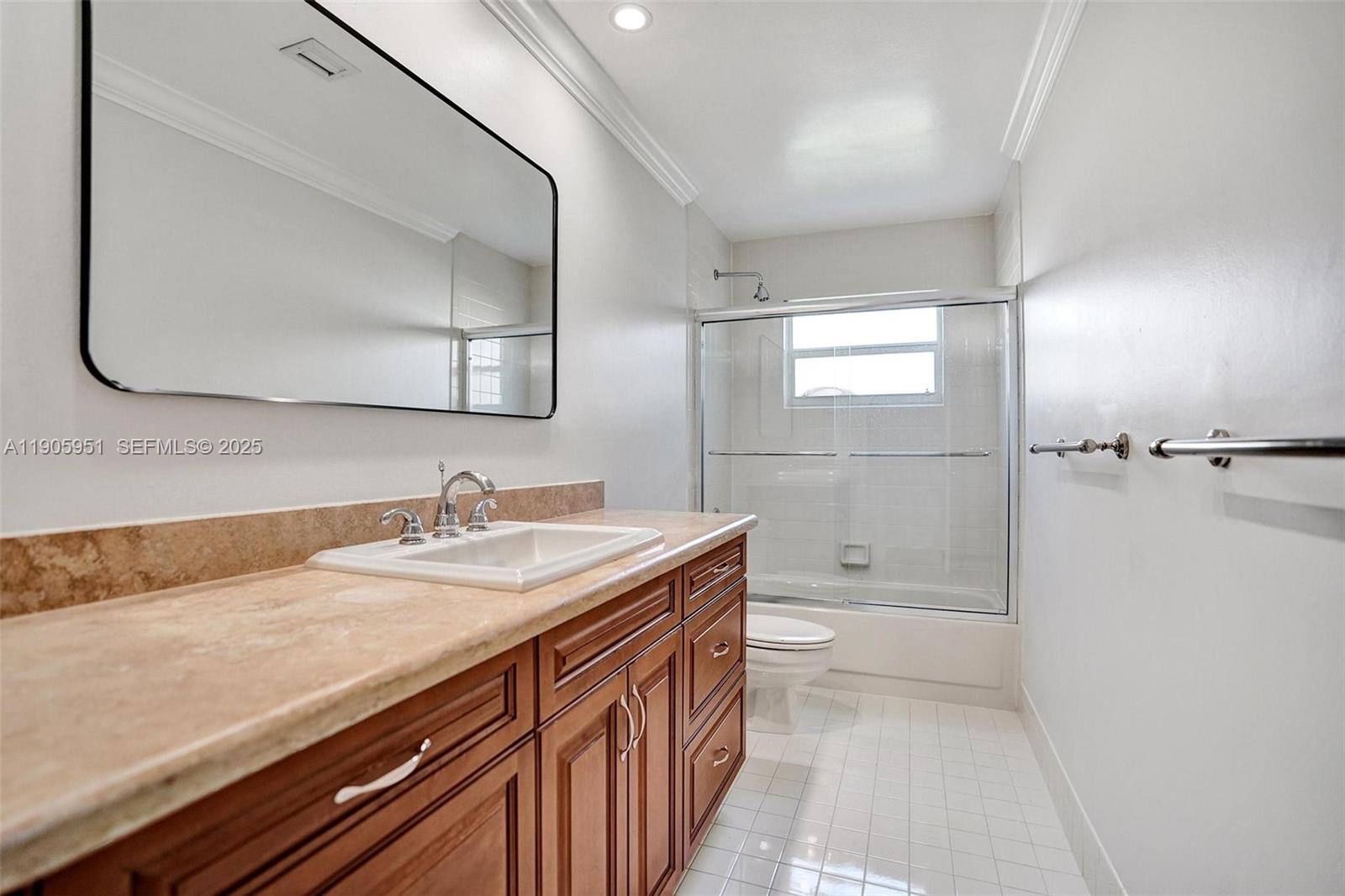 3801 Northwest 27th Avenue Boca Raton, FL 33434 - Photo 76 of 100 a bathroom with a sink a toilet and mirror