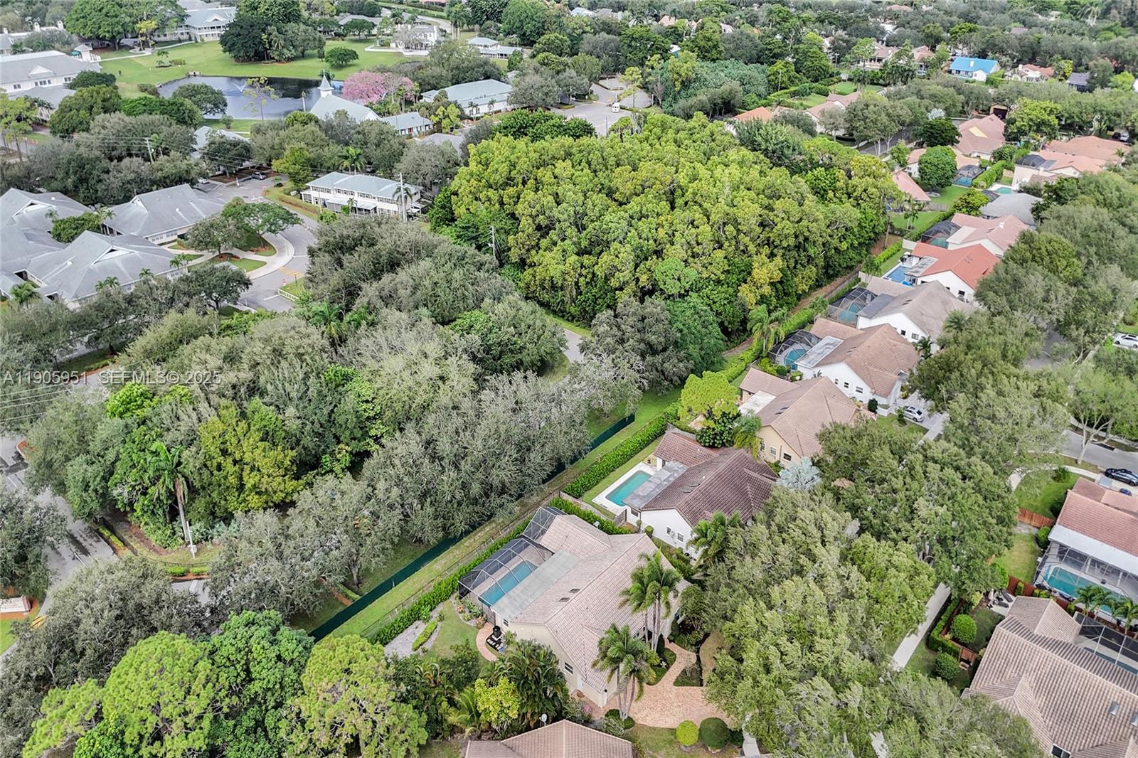 3801 Northwest 27th Avenue Boca Raton, FL 33434 - Photo 93 of 100 an aerial view of residential houses with outdoor space and trees all around