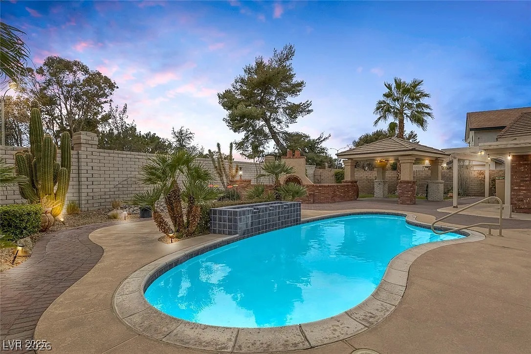 9 Quail Run Road Henderson, NV 89014 - Photo 41 of 57 An inviting pool area with a covered gazebo, perfect for outdoor entertainment.
