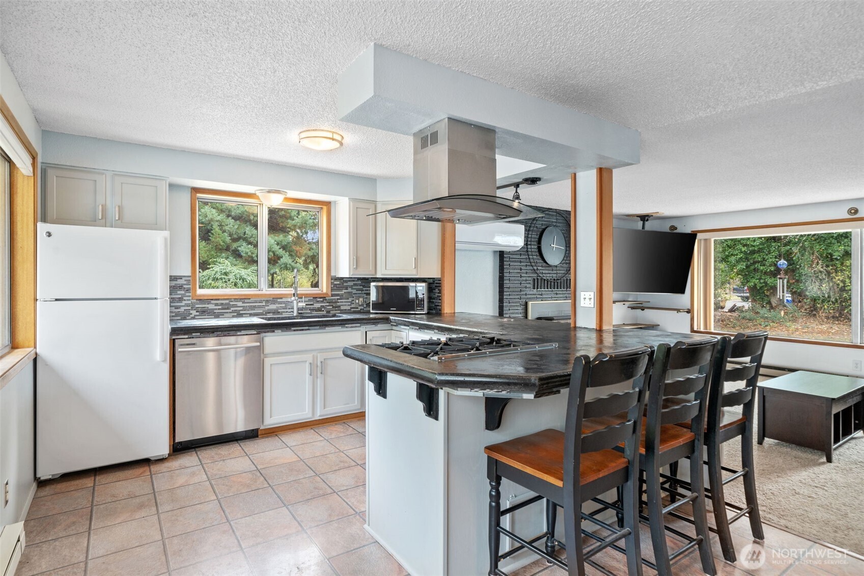 265 Cays Road Sequim, WA 98382 - Photo 11 of 40 a kitchen with stainless steel appliances granite countertop a stove a refrigerator and a dining table