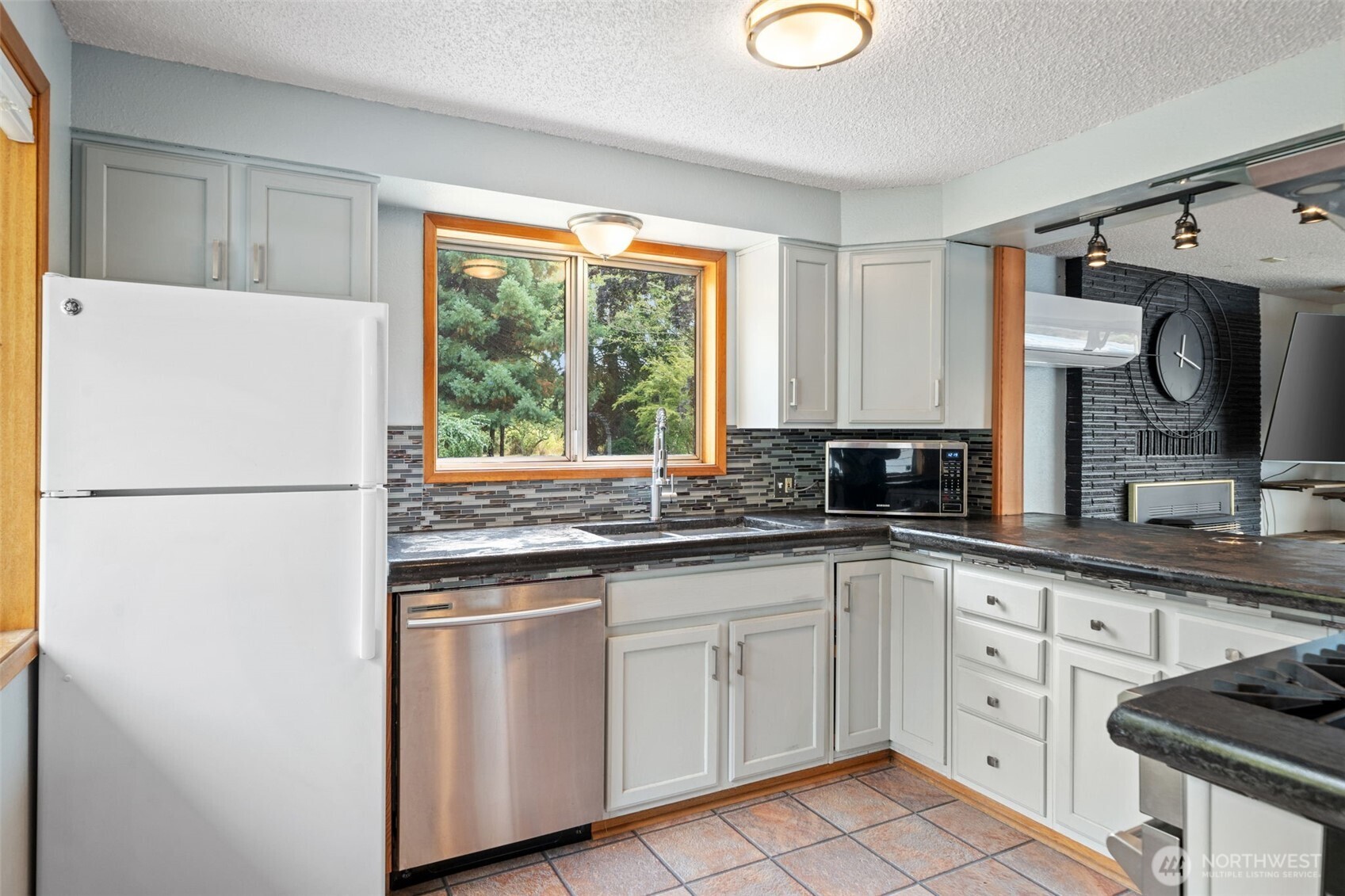 265 Cays Road Sequim, WA 98382 - Photo 13 of 40 a kitchen with white cabinets and white appliances