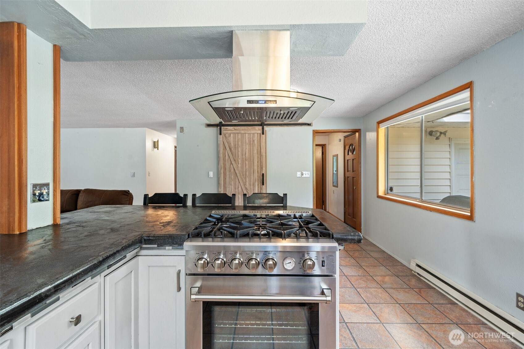 265 Cays Road Sequim, WA 98382 - Photo 17 of 40 a kitchen with stainless steel appliances granite countertop a stove a sink and a refrigerator