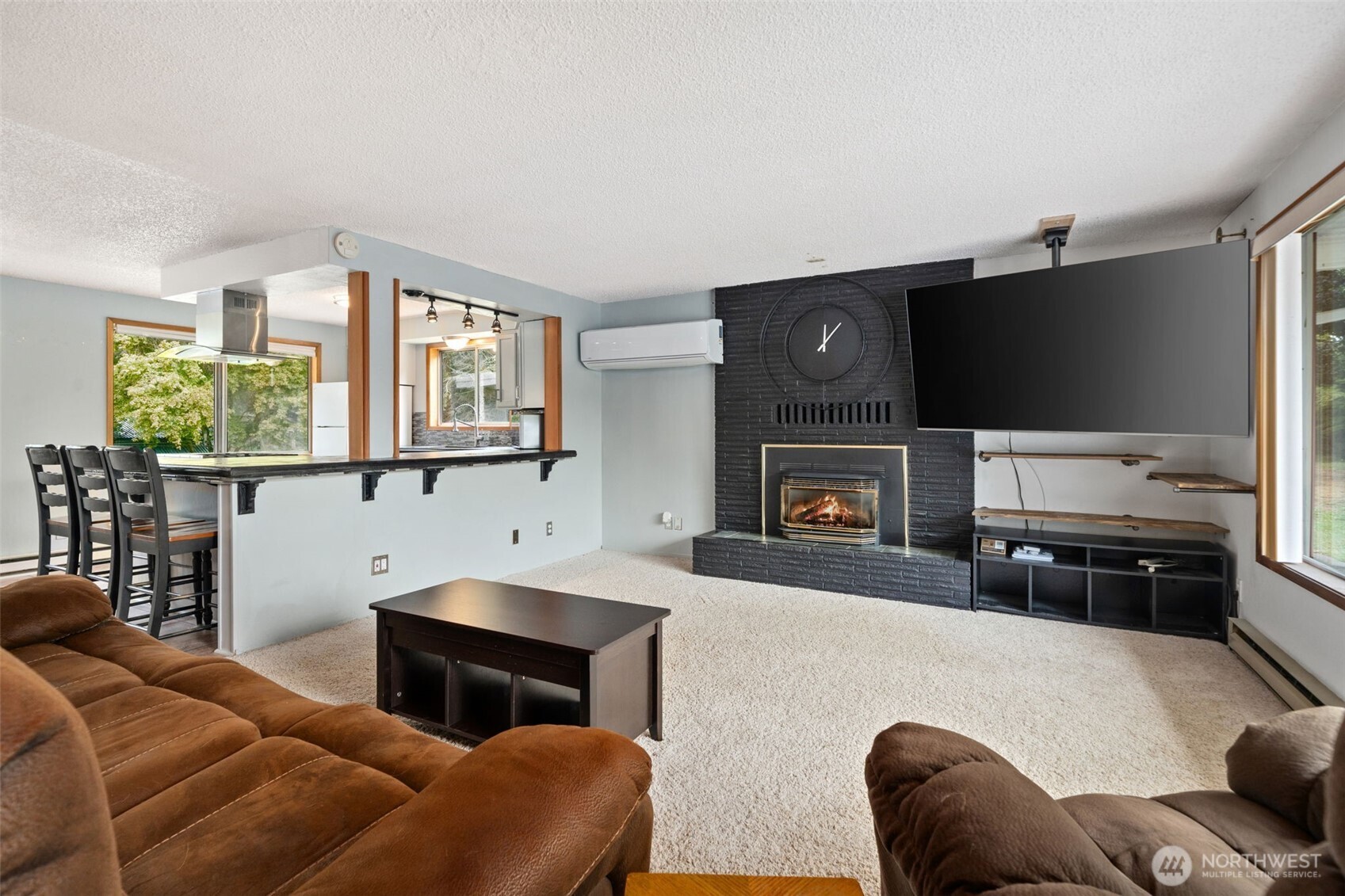 265 Cays Road Sequim, WA 98382 - Photo 3 of 40 a living room with furniture a flat screen tv and a fireplace