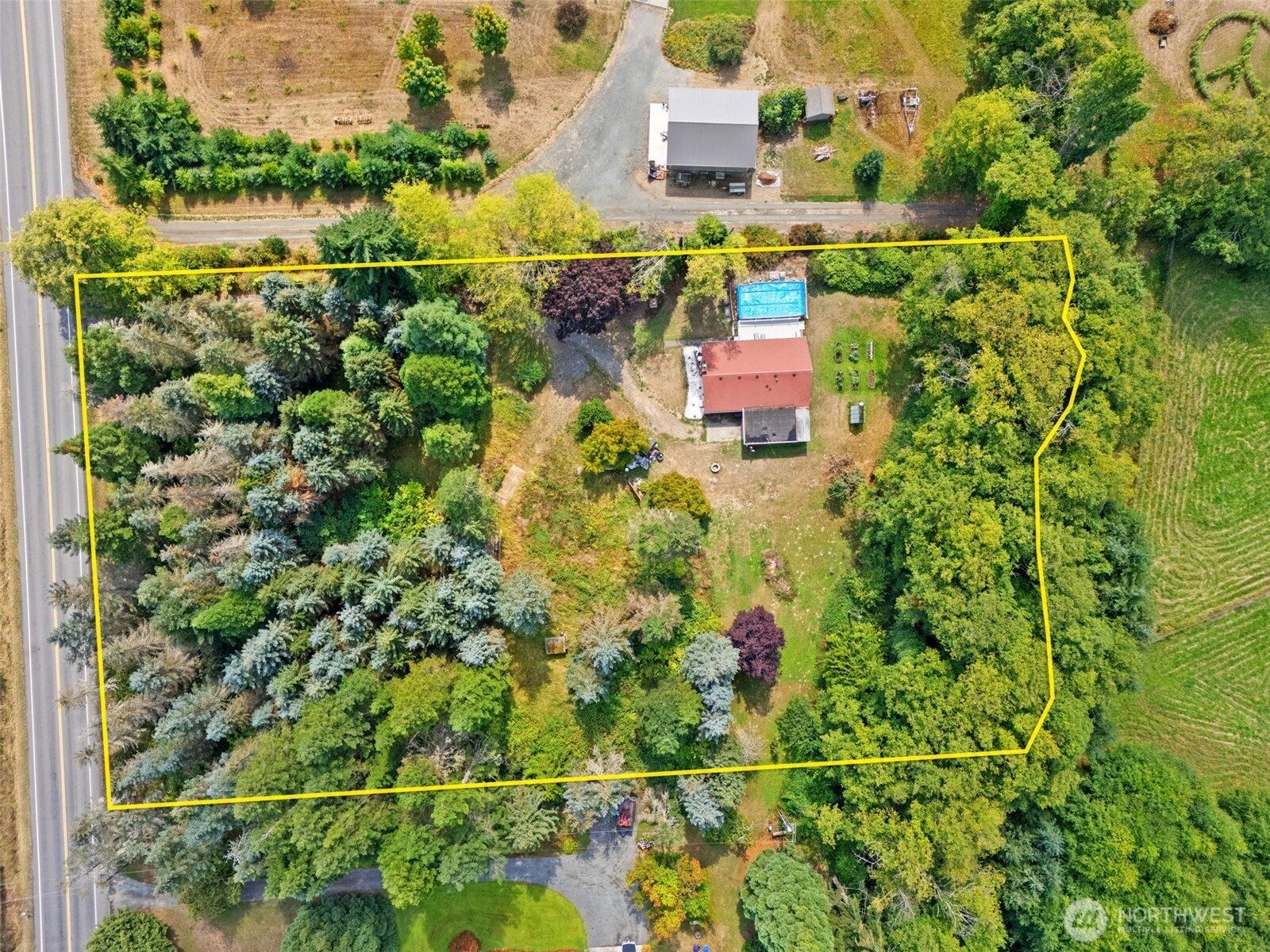 265 Cays Road Sequim, WA 98382 - Photo 32 of 40 an aerial view of residential houses with outdoor space and trees