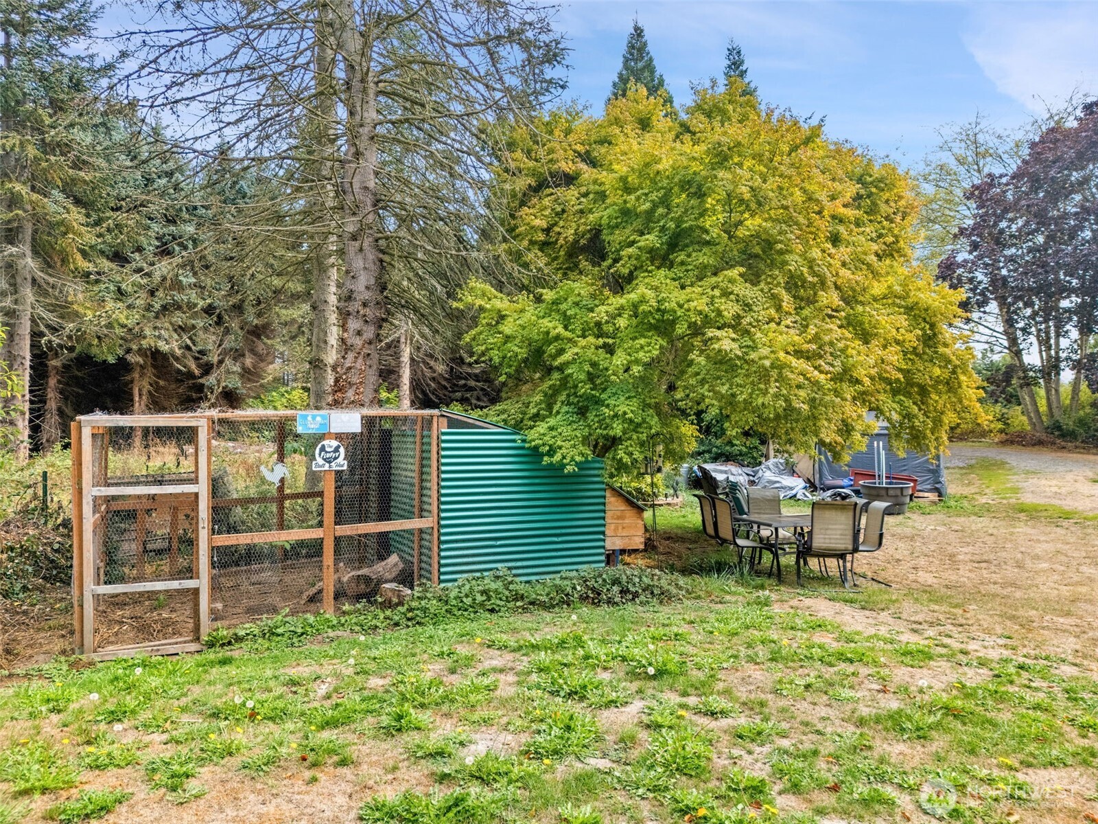 265 Cays Road Sequim, WA 98382 - Photo 37 of 40 a view of a backyard with wooden fence and a bench