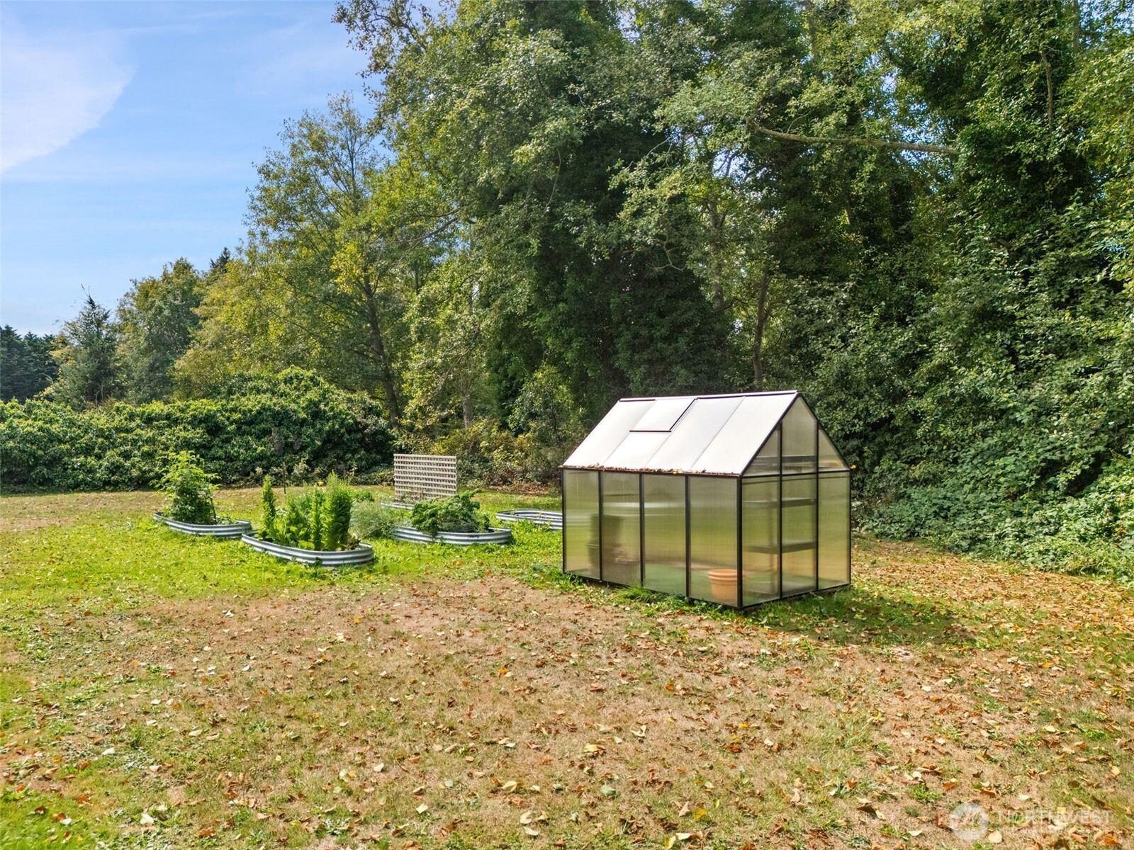 265 Cays Road Sequim, WA 98382 - Photo 39 of 40 a backyard of a house with a garden and deck