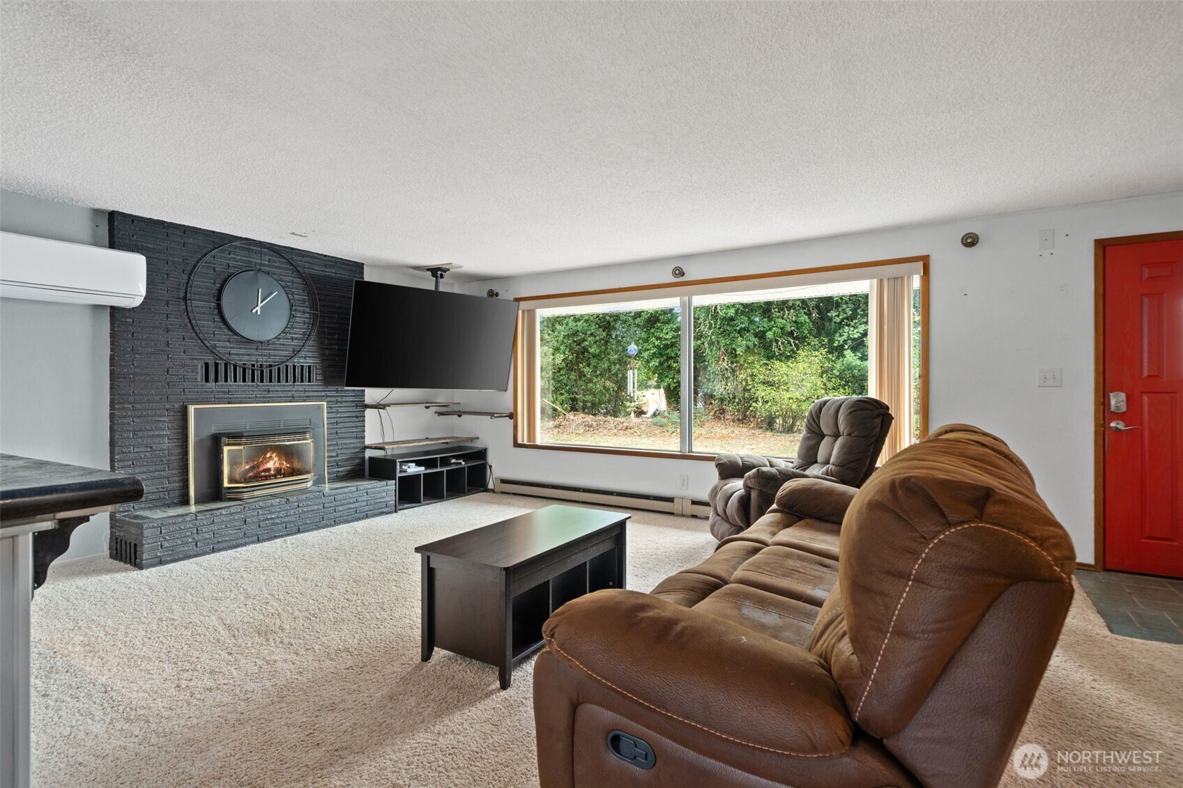 265 Cays Road Sequim, WA 98382 - Photo 4 of 40 a living room with furniture a fireplace and a flat screen tv