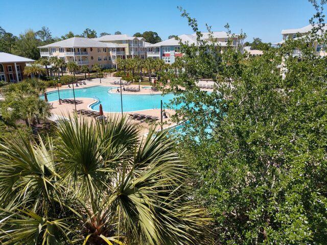 8700 Front Beach Road, Unit 5313 Panama City Beach, FL 32407 - Photo 34 of 38 a view of a swimming pool with outdoor seating and plants