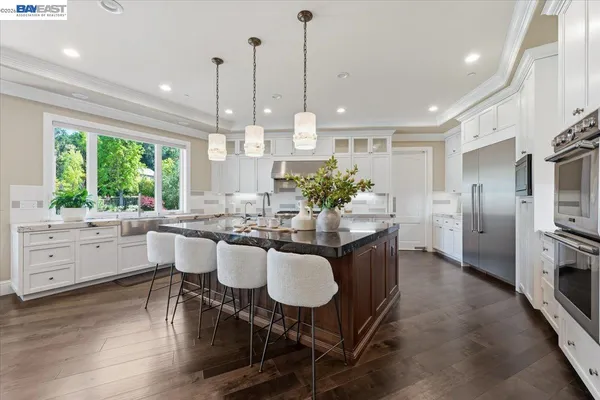 a kitchen with granite countertop stainless steel appliances and cabinets
