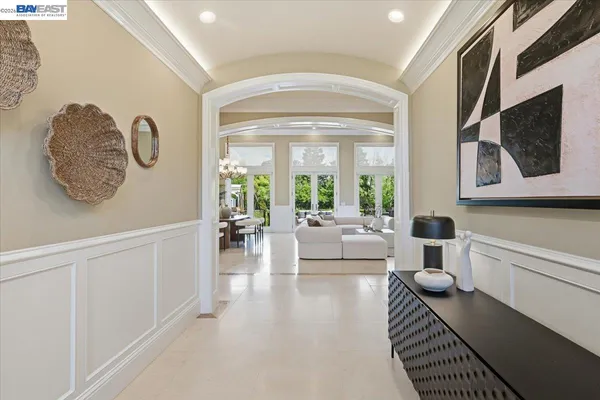 a living room with furniture fireplace and a large window
