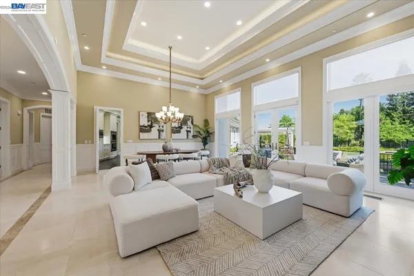 a living room with furniture a fireplace and a large window