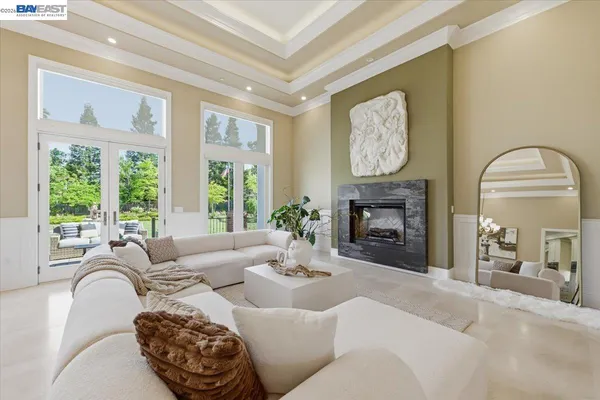a living room with furniture and a chandelier