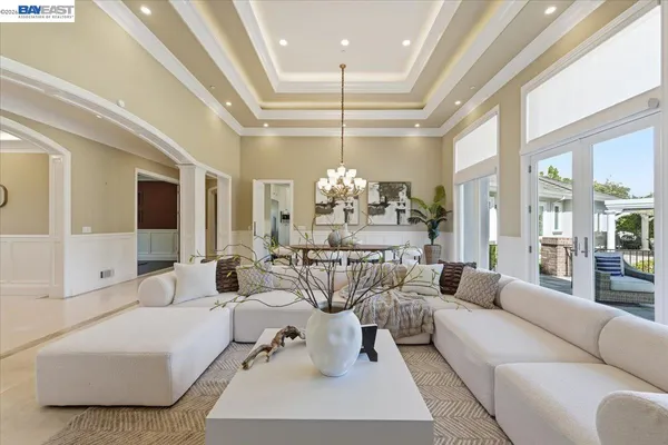 a view of a dining room with furniture wooden floor and chandelier