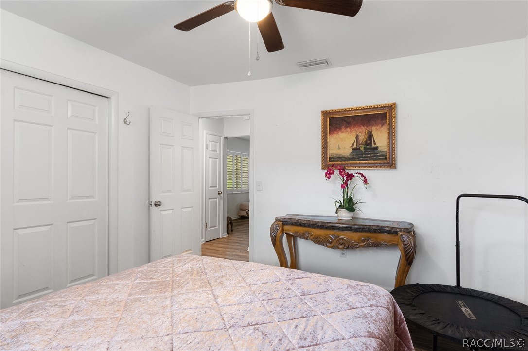 1140 South Highlands Avenue Inverness, FL 34452 - Photo 32 of 54 a bedroom with a bed and a painting on the wall