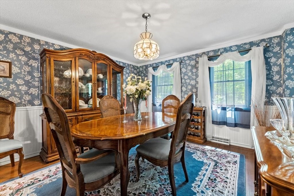 299 Bennett Road Hampden, MA 01036 - Photo 13 of 41 a dining room with furniture a chandelier and wooden floor