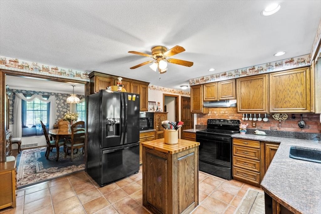 299 Bennett Road Hampden, MA 01036 - Photo 16 of 41 a kitchen with stainless steel appliances granite countertop a sink stove and refrigerator