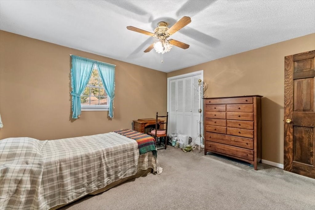 299 Bennett Road Hampden, MA 01036 - Photo 31 of 41 a bedroom with a bed and a chandelier