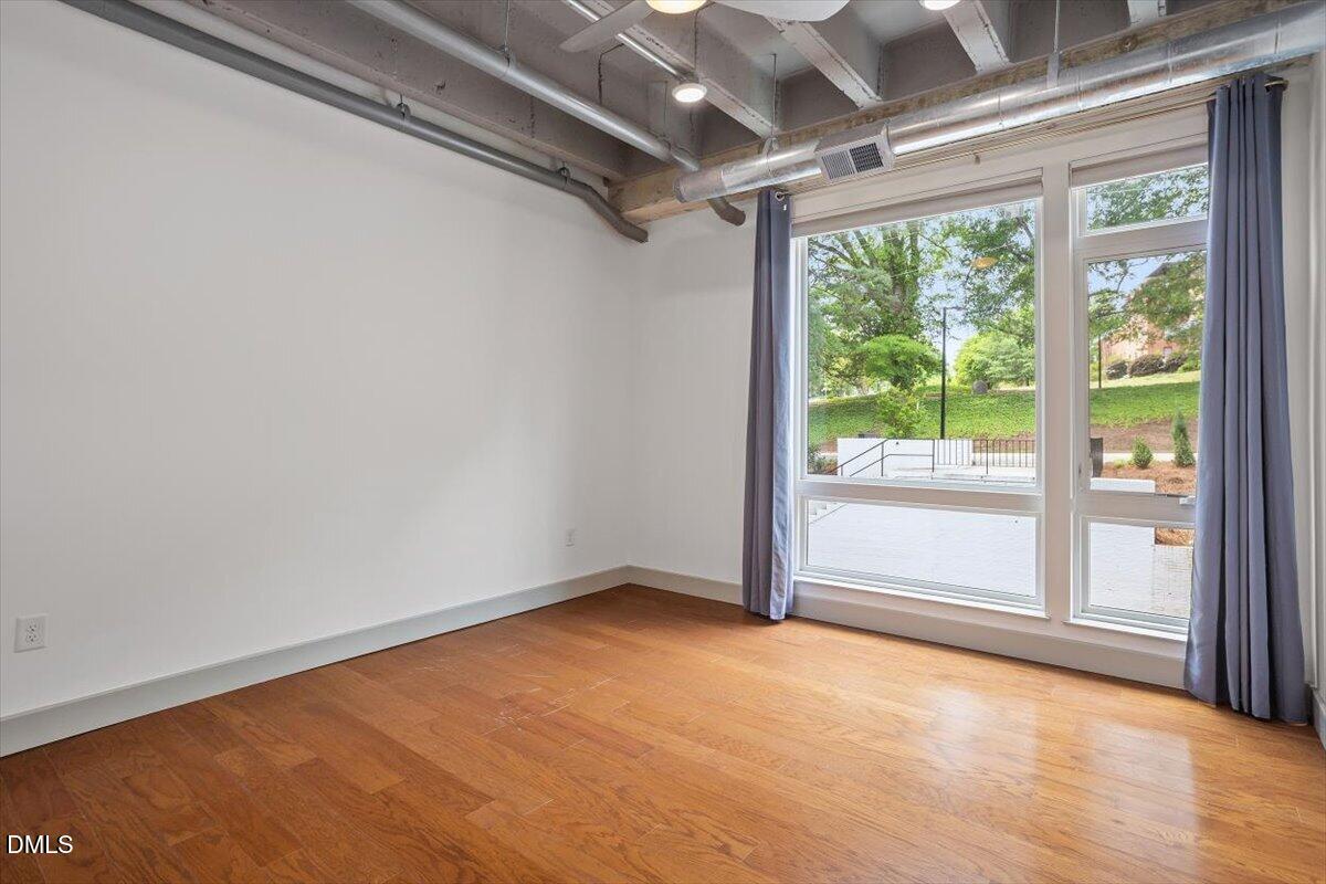 1300 St Marys Street, Unit 207 Raleigh, NC 27605 - Photo 8 of 31 a view of an empty room with a window