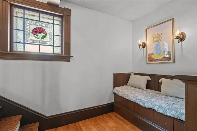 a living room with furniture and a wall painting